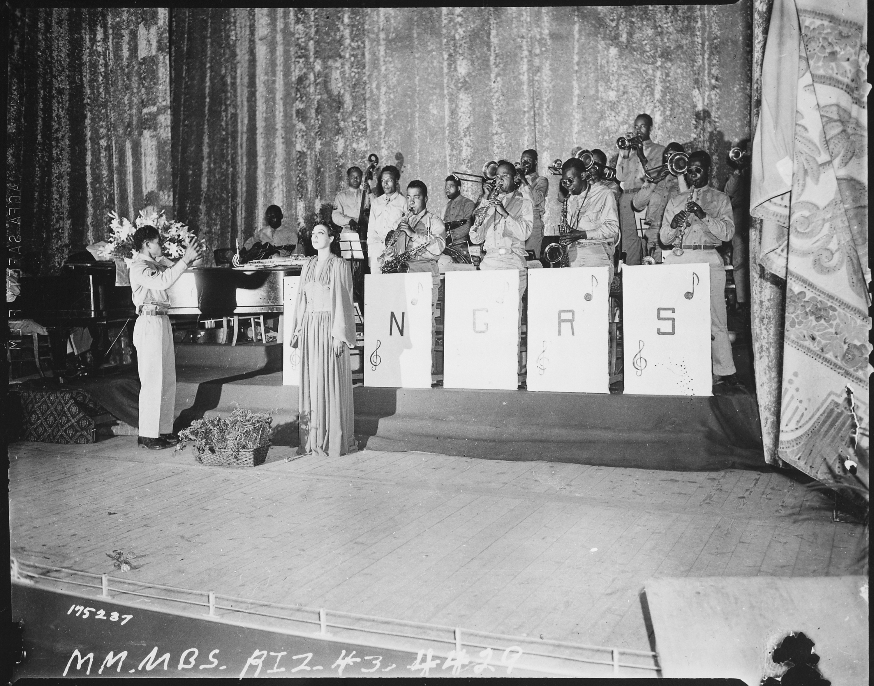 Josephine Baker sings with a military band on stage in Oran during the Second World War