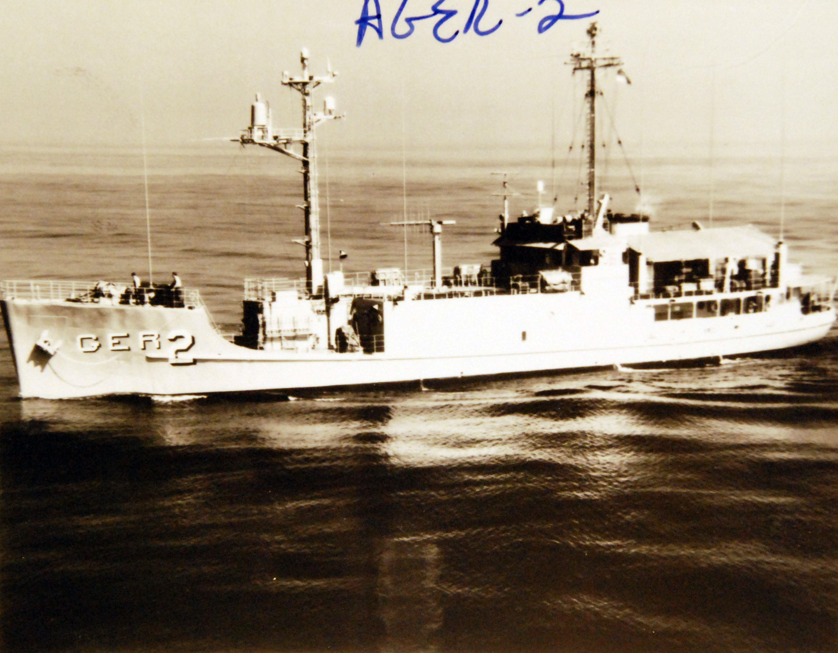 USS Pueblo underway off San Diego, showing its compact hull, mast and antenna equipment