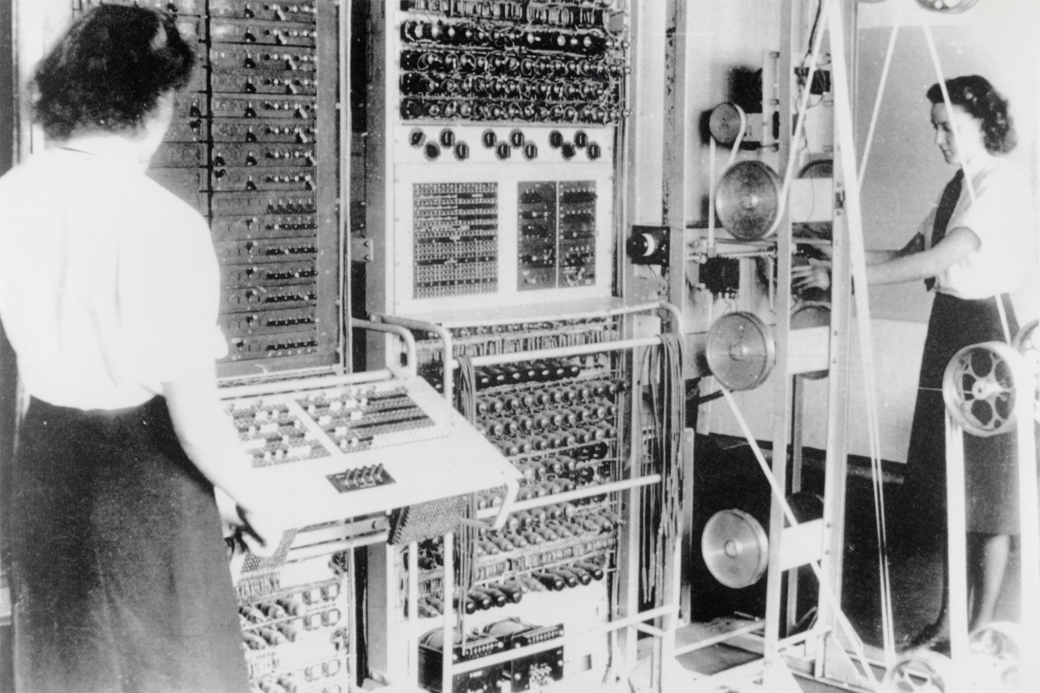 Wartime Colossus computer with two women operating its equipment