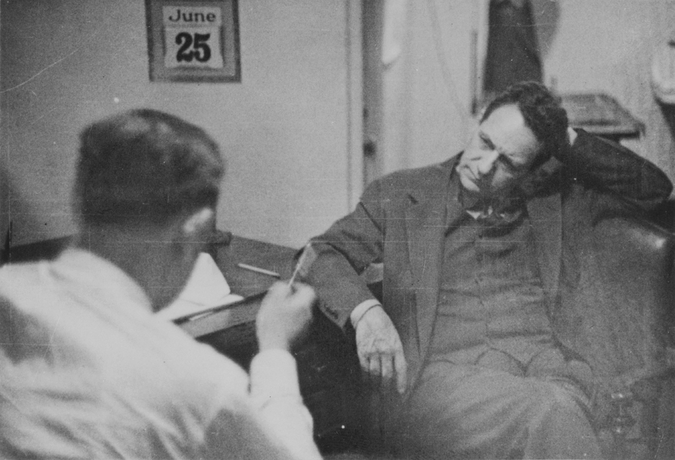 William Sebold and Fritz Duquesne seated across a desk in a meeting secretly recorded by the FBI