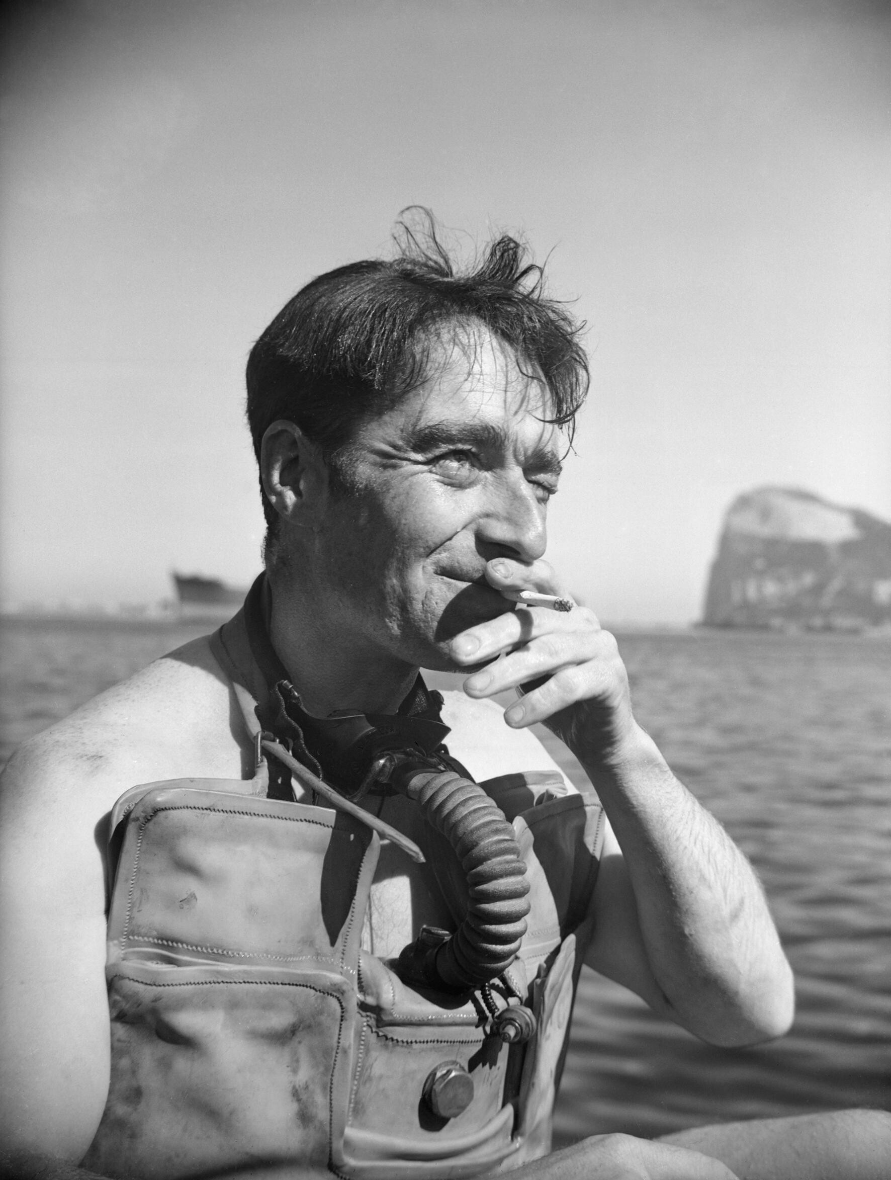 Lionel Crabb wearing diving equipment at Gibraltar, a cigarette in his mouth